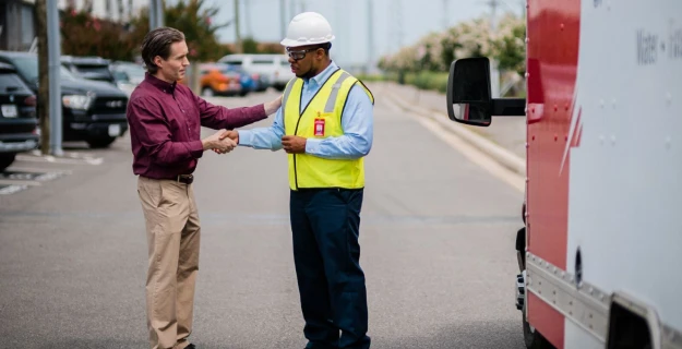 Rainbow Restoration service professional speaking with a commercial property owner.