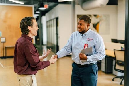 Customer shaking hands with Rainbow Restoration team member.