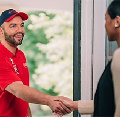 Rainbow Restoration tech shaking hands with customer.